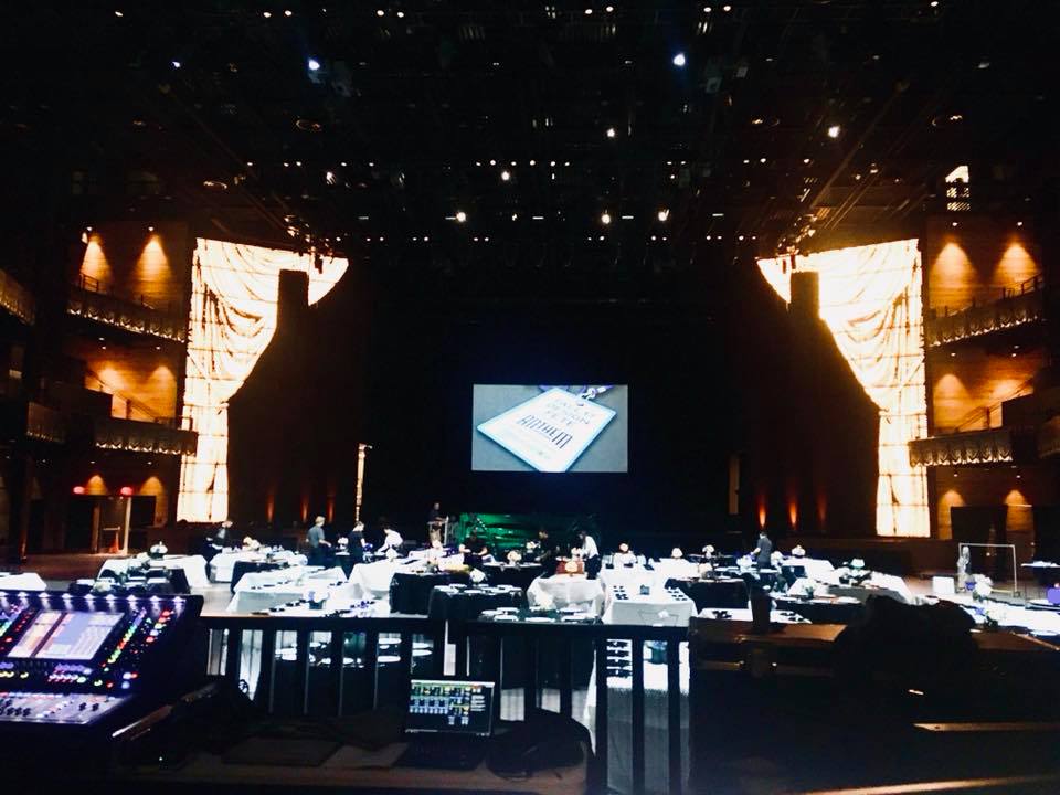 a picture of an event with staging, lighting and video